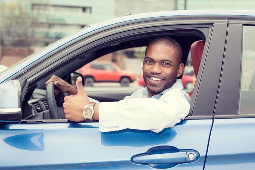 Man driver happy smiling showing thumbs up driving sport blue car